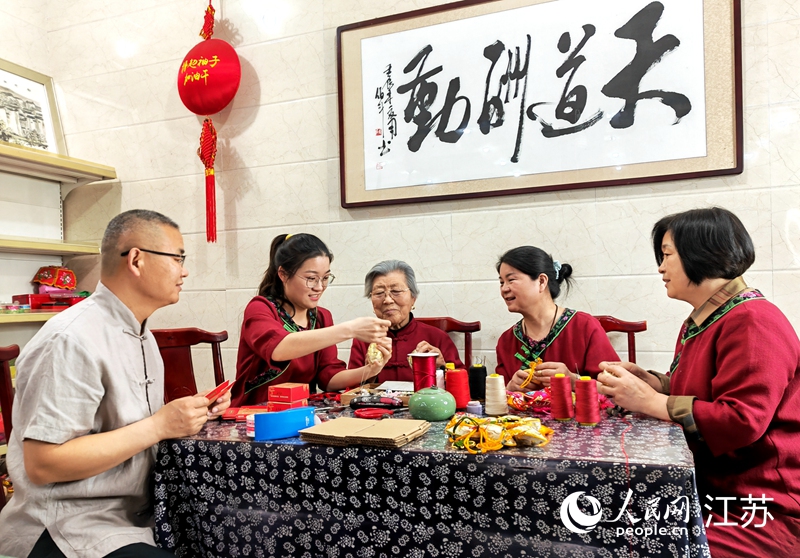 王秀英老人指導(dǎo)孫女制作香包。人民網(wǎng) 閆峰攝