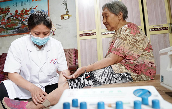 護(hù)理團(tuán)隊醫(yī)生為老人進(jìn)行低頻功能康復(fù)。陳佳兵攝