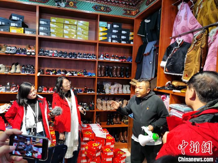 圖為中外媒體在玉樹州玉樹市甘達(dá)村采訪?！?zhí)砀?攝